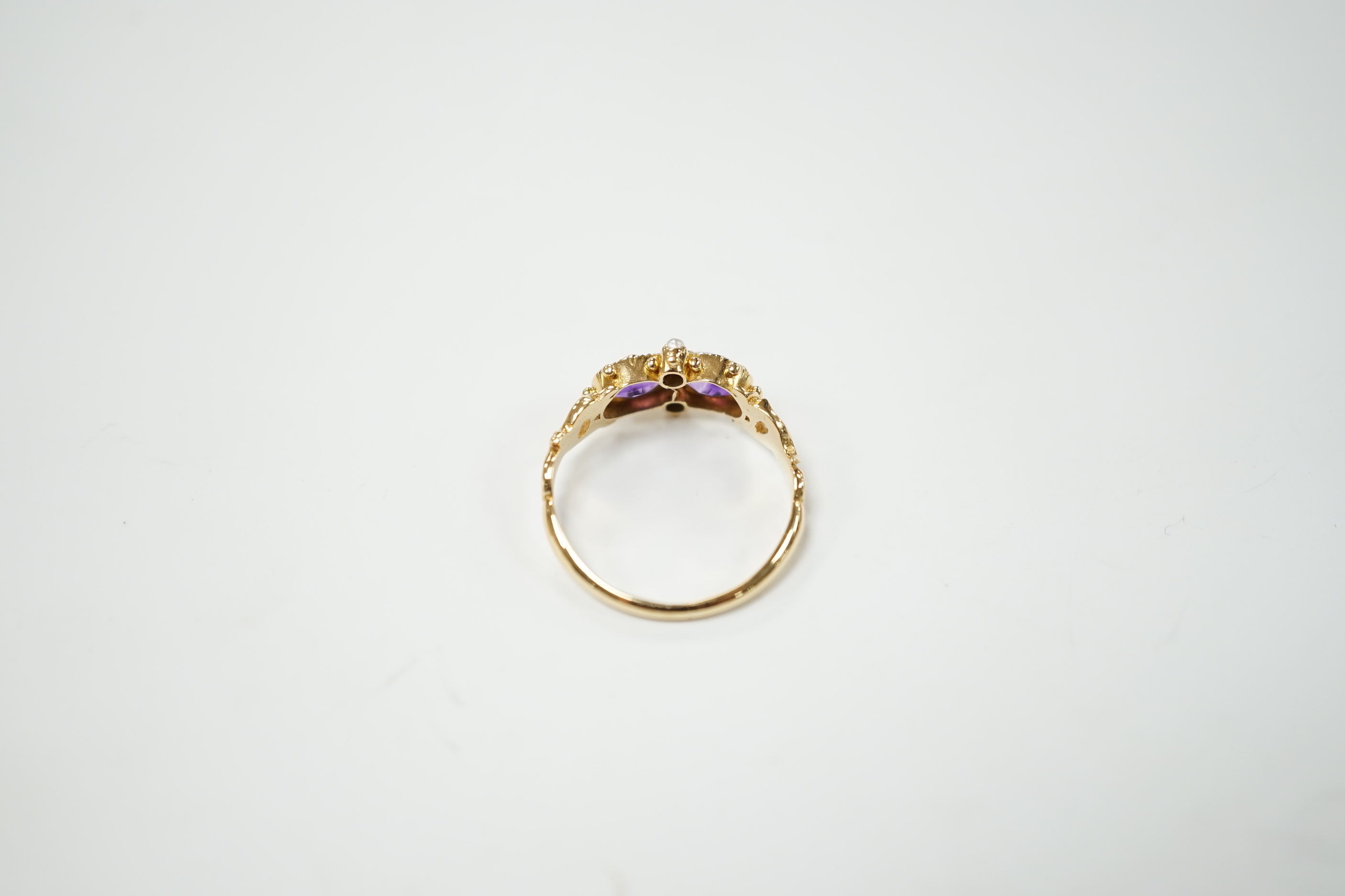 A Victorian style yellow metal, amethyst and pearl dress ring, size L